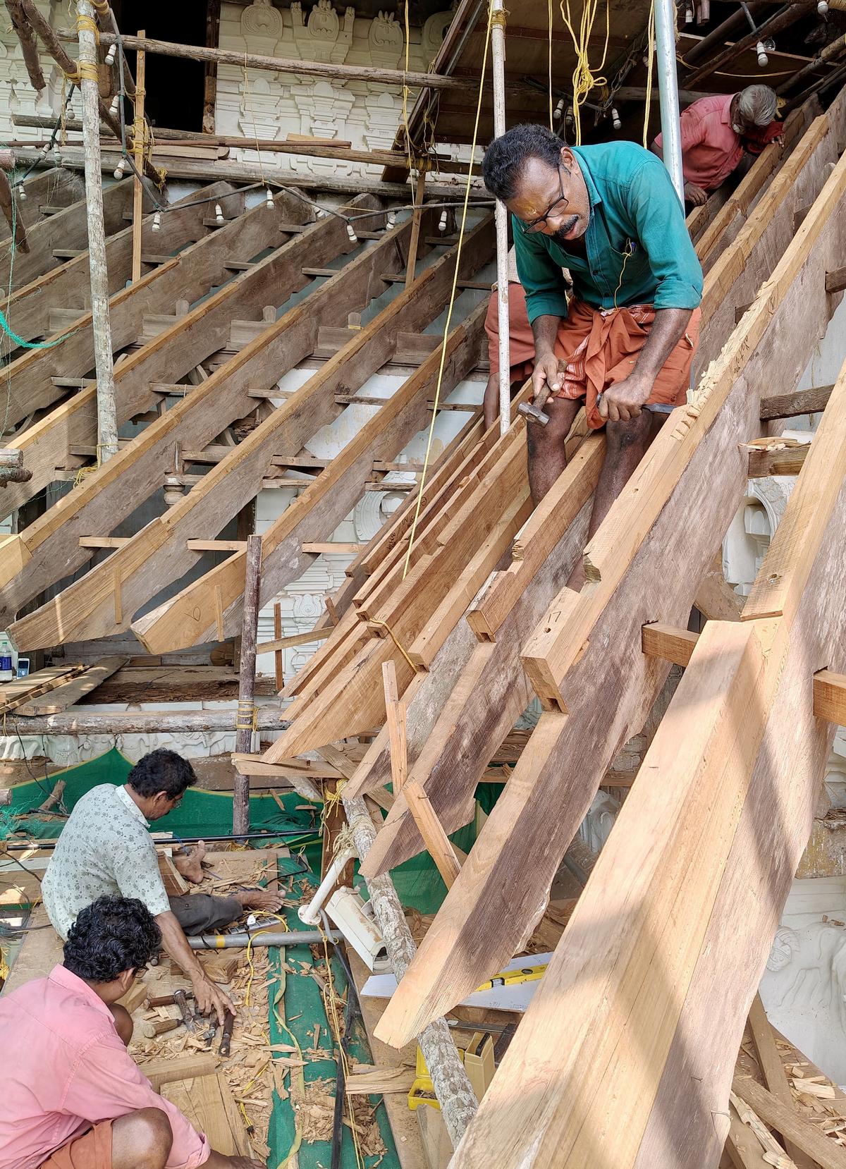 Artisans carrying out the restoration work of the east gopuram of Sree Vadakkunnathan Temple in Thrissur.